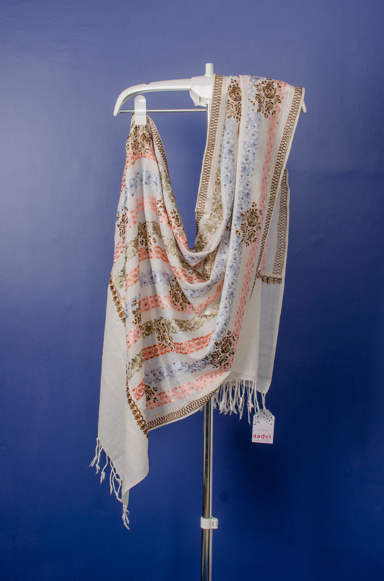 WHITE WOVEN PASHMINA STOLE WITH BEAUTIFUL THREAD EMBROIDERY AND HIGHLIGHTED WITH STONE PASTING.