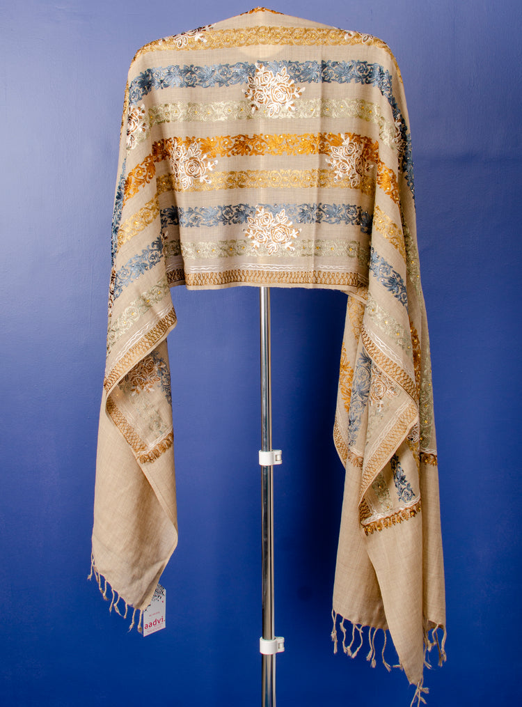 BEIGE WOVEN PASHMINA STOLE WITH BEAUTIFUL THREAD EMBROIDERY AND STONE PASTING.
